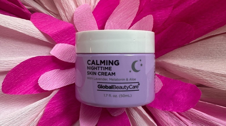 Global Beauty Care's Calming Nighttime Skin Cream on a floral backdrop
