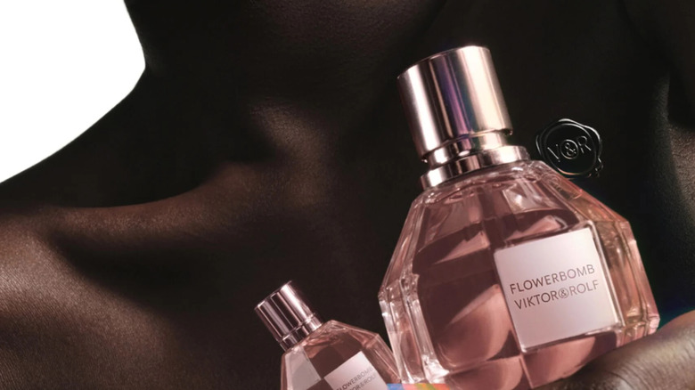 Model holding Flowerbomb perfume bottle