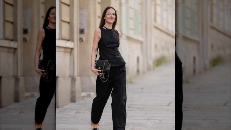 Woman wearing black linen vest and pants