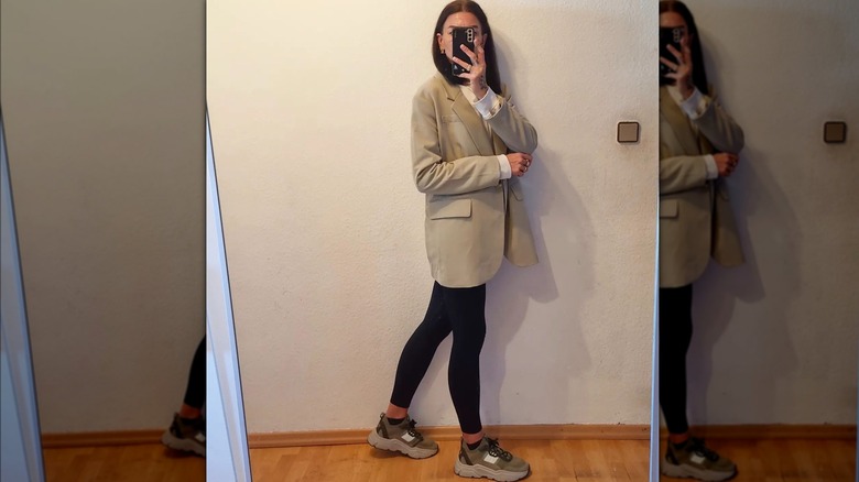 Woman in leggings, sneakers, and blazer