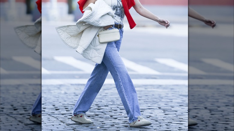 Gigi Hadid walks through New York streets wearing jeans with  Birkenstock Boston clogs