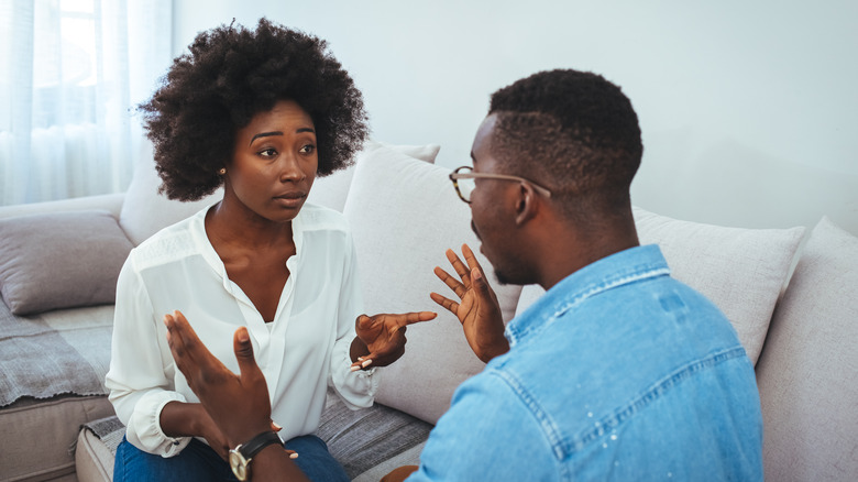 Concerned woman talking to man