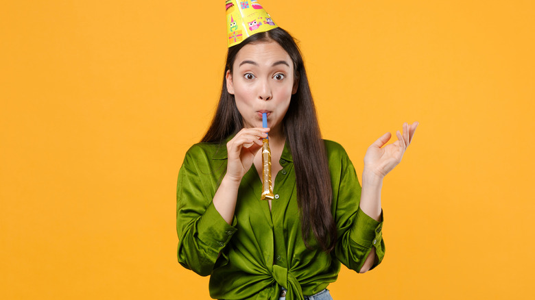 Woman wearing a birthday hat 