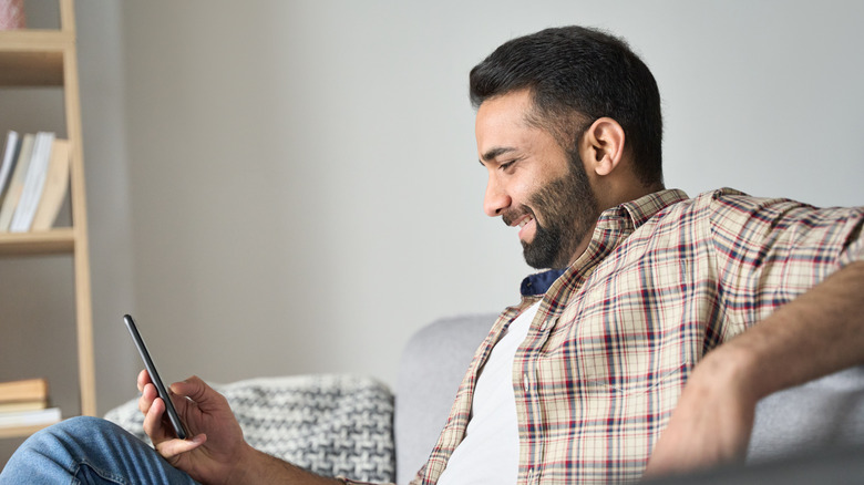 Man smiling at phone