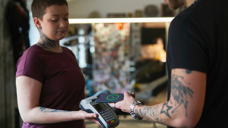 Tattoo artist is paid with credit card
