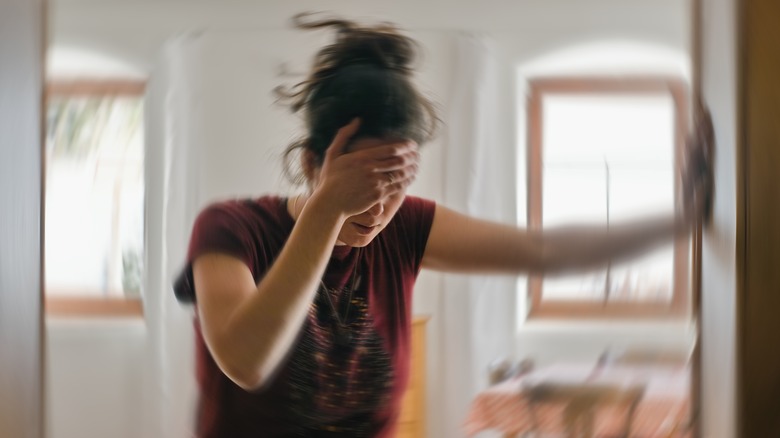 Woman with headache spinning