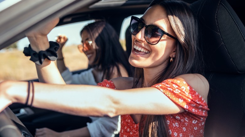 Two girls laughing in car