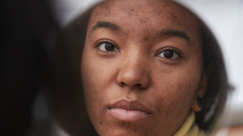 woman looking at herself in the mirror