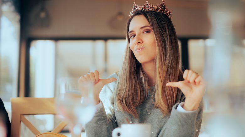 Arrogant woman wearing crown