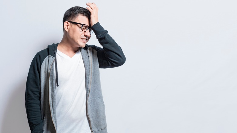 Man with hand on forehead