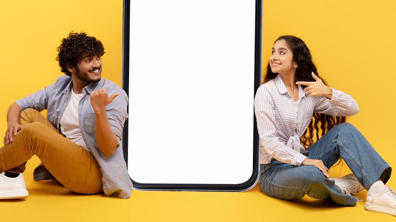 Couple sitting between a phone