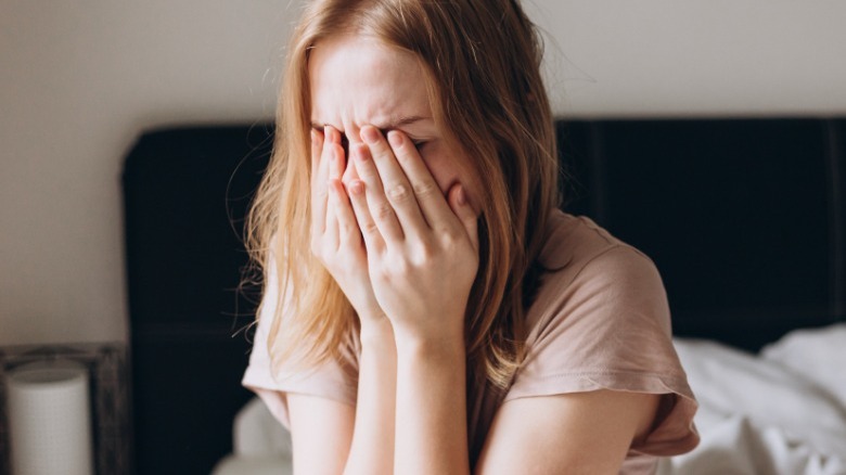 Woman crying in bed