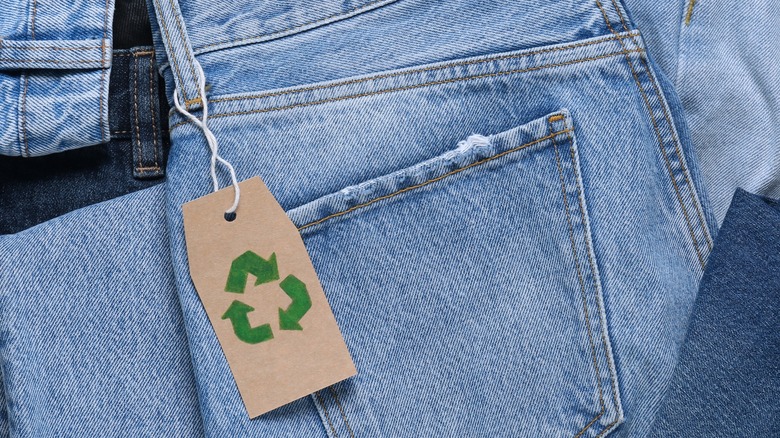Jeans with a recycling symbol on the tag