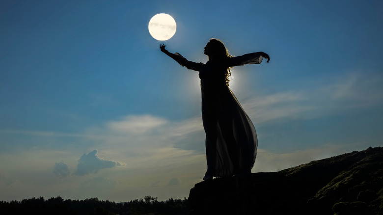 woman holding the moon