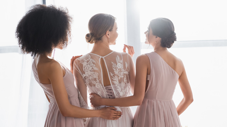 Bridemaids helping bride get ready