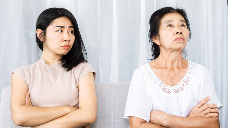 daughter and mother crossing arms