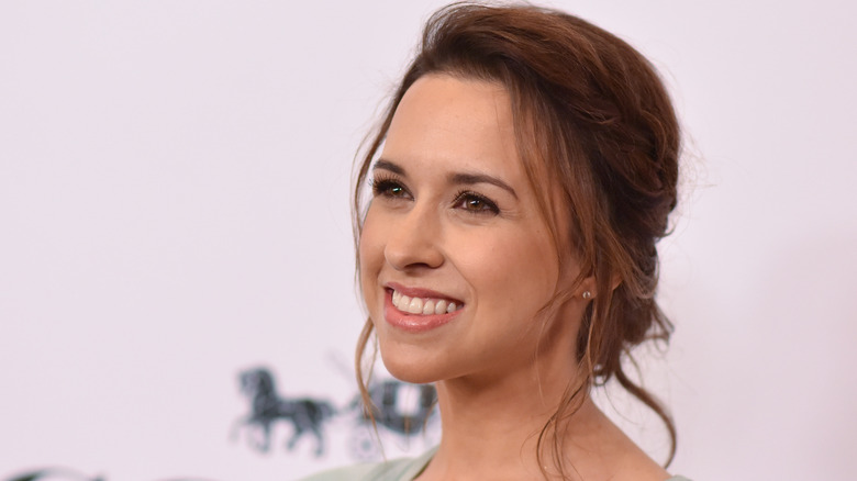 Lacey Chabert smiles for photos on a red carpet