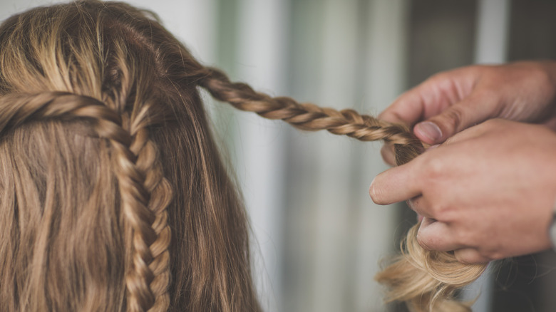 A person braiding hair