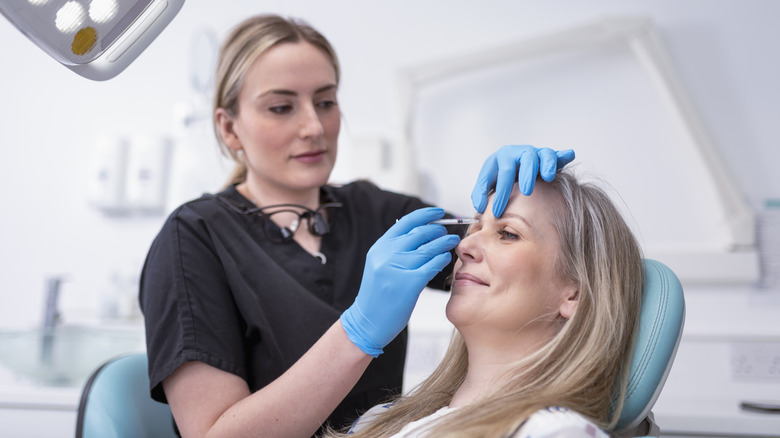 A nurse injecting a patient with a Botox needle