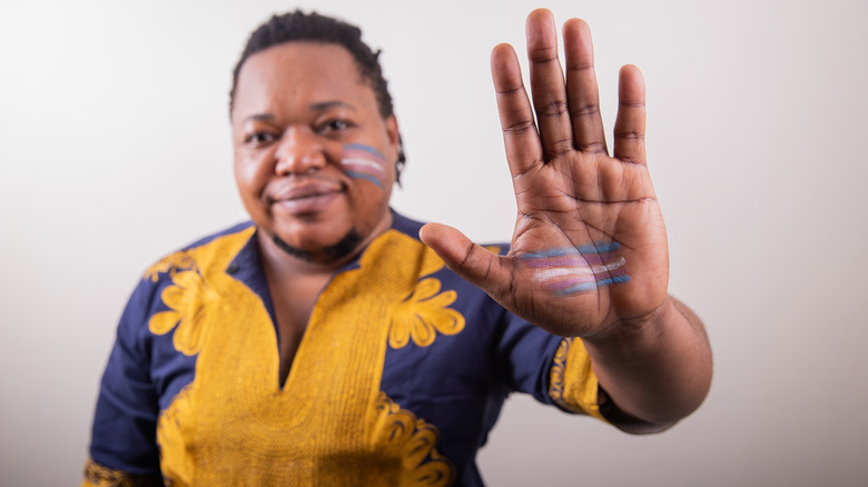 trans man with transgender flag 