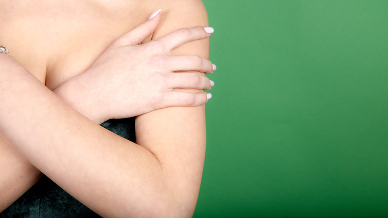 Person with arms crossed over chest