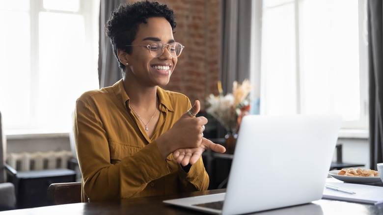 Woman at her laptop, smiling
