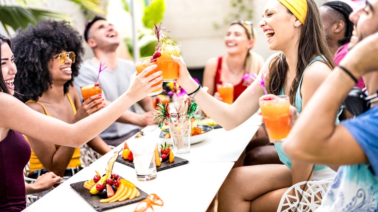 Friends drinking cocktails outside