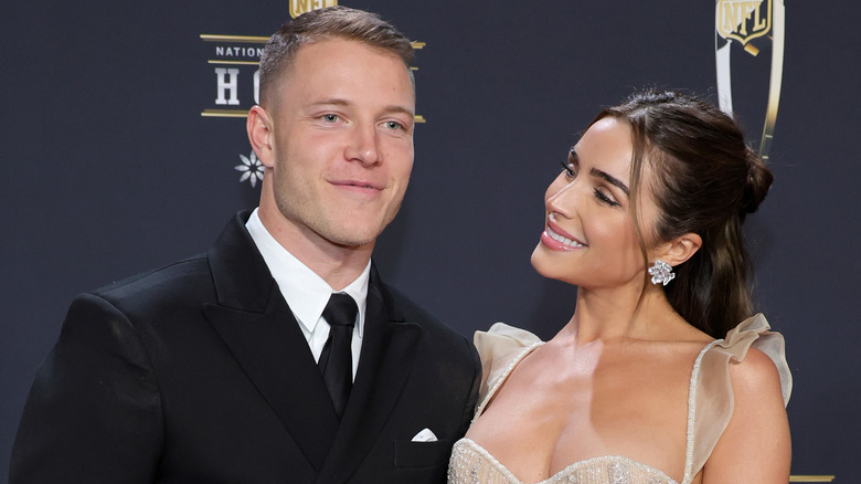 Olivia Culpo smiling at Christian McCaffrey