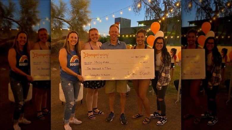 Man holding a large $10,000 check