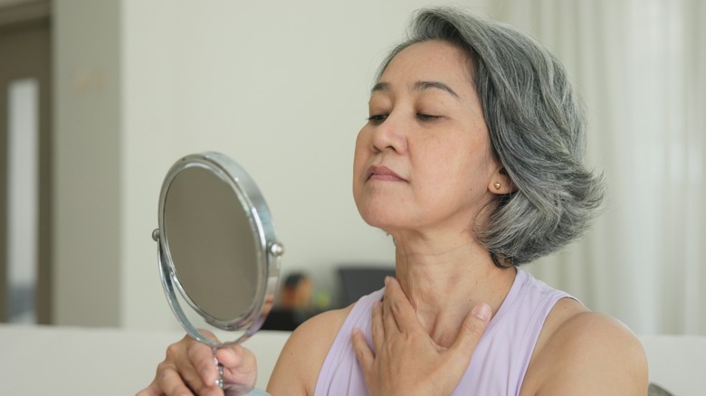 A woman touching her neck