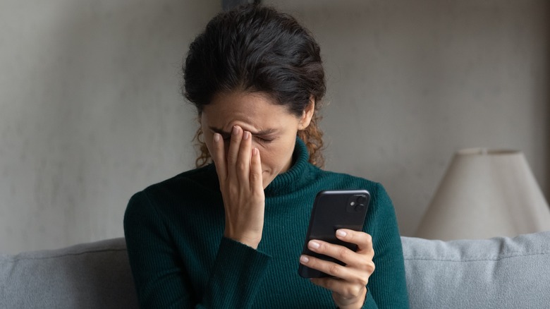 Woman distressed on her phone