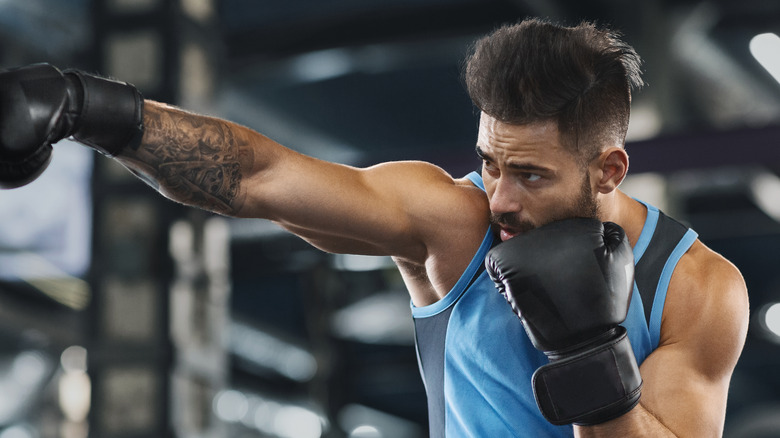 Man punches with boxing gloves
