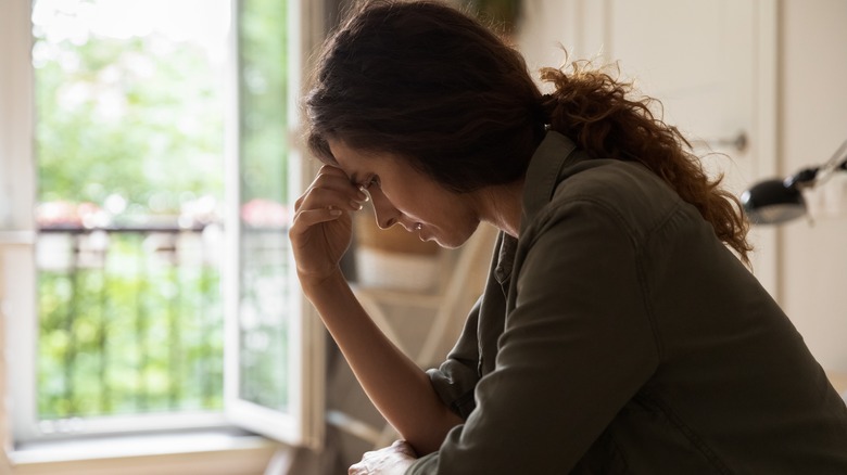 Frustrated young woman holding head