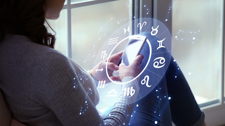 woman looking at birth chart