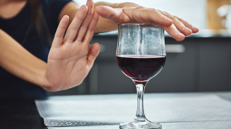 person refusing wine