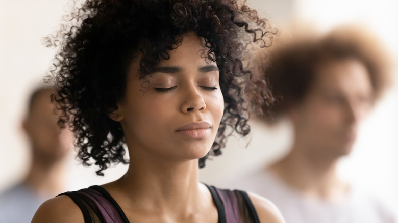 woman meditating in yoga class