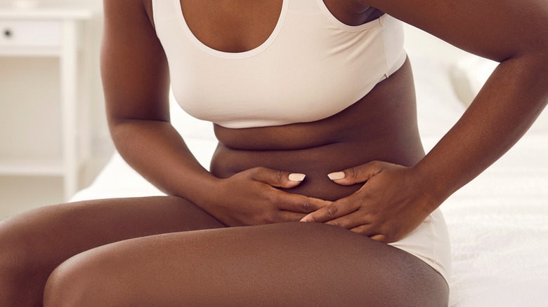 woman holding stomach