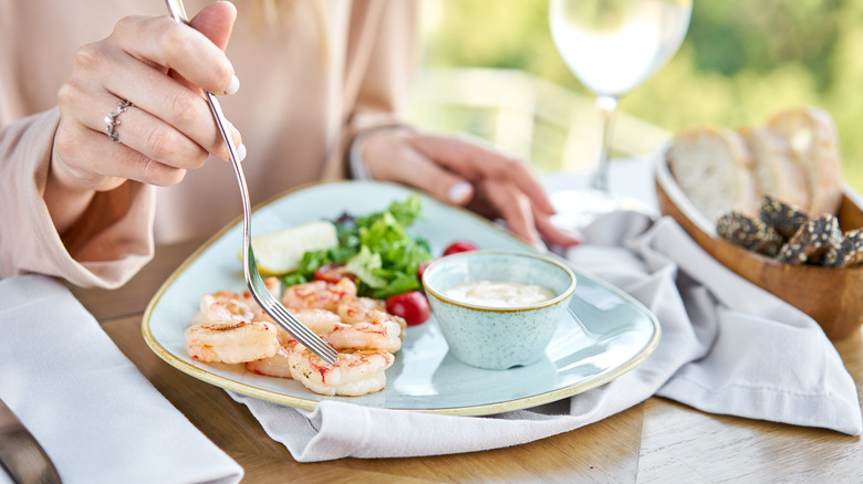 Woman eats seafood platter 
