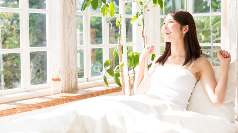 woman wearing a camisole in bed