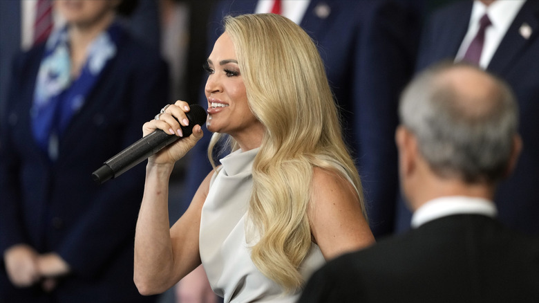 Carrie Underwood holds a microphone while singing "America The Beautiful" at President Donald Trump's Inauguration in 2025