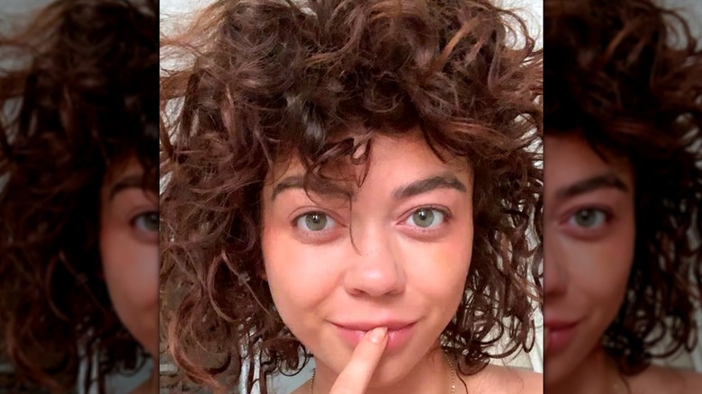A selfie of Sarah Hyland with curly hair and no makeup.