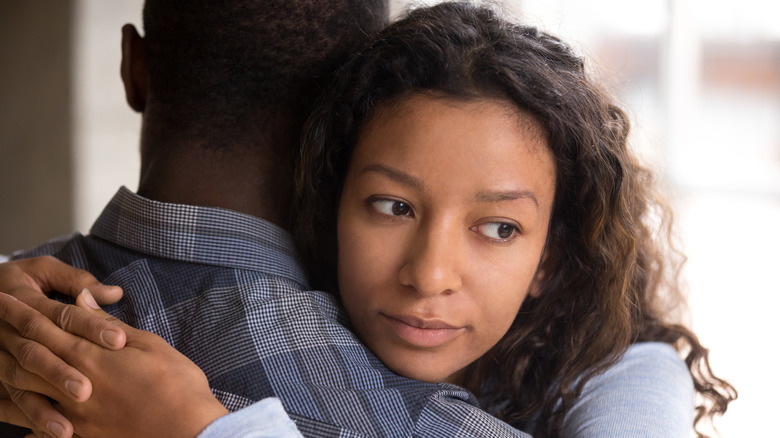 African American woman hugging a man