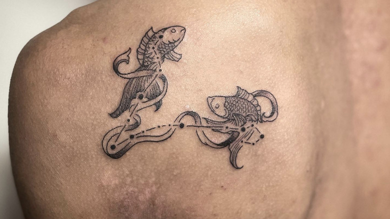 Fish attached to Pisces constellation tattoo
