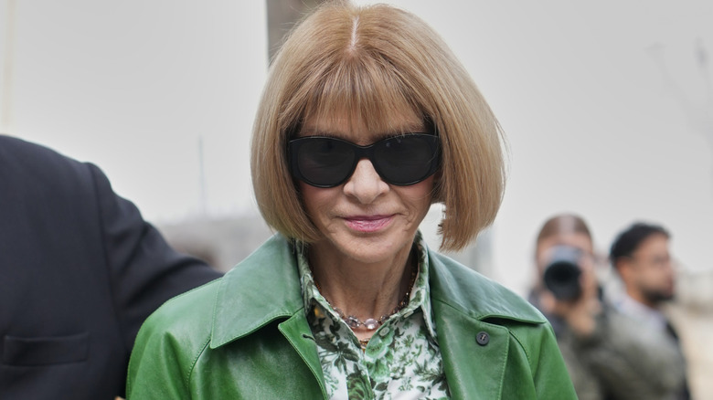 Anna Wintour wearing sunglasses and a green outfit