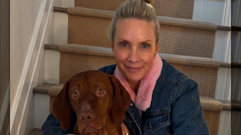 Fox News host Dana Perino smiling while makeup-free with her dog