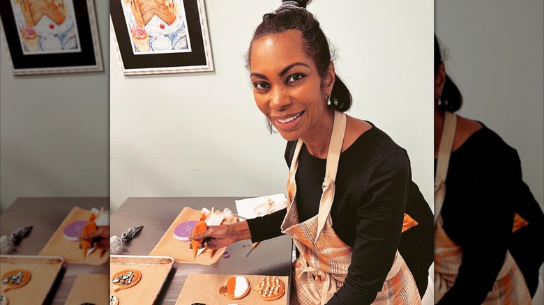 Fox News host Harris Faulkner wearing a half updo while decorating cookies makeup-free