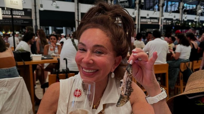 Fox News host Jeanine Pirro holding a sardine in a makeup-free photo
