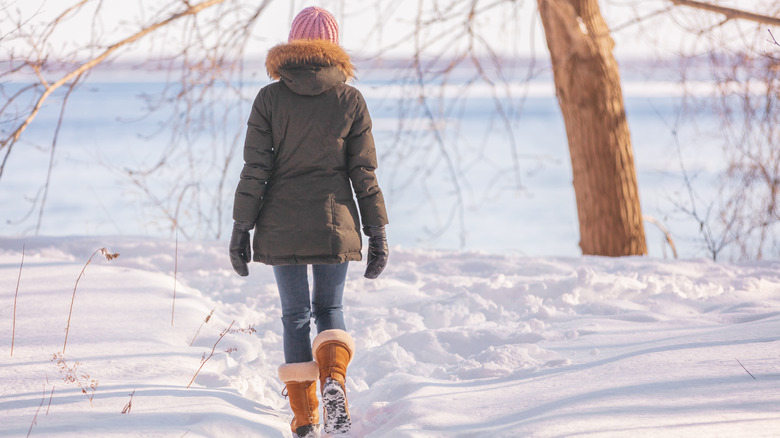 woman wearing coat in snow