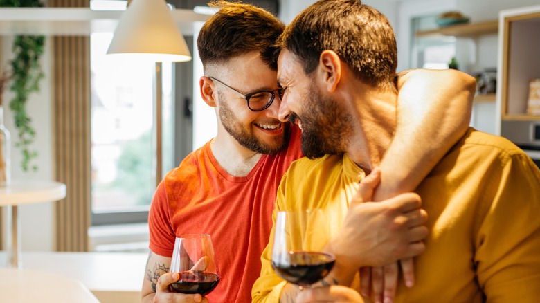gay couple hugging and smiling