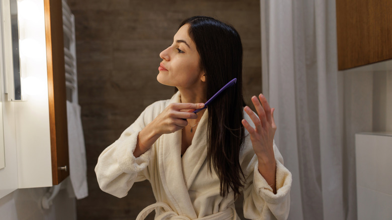 Woman combing her hair